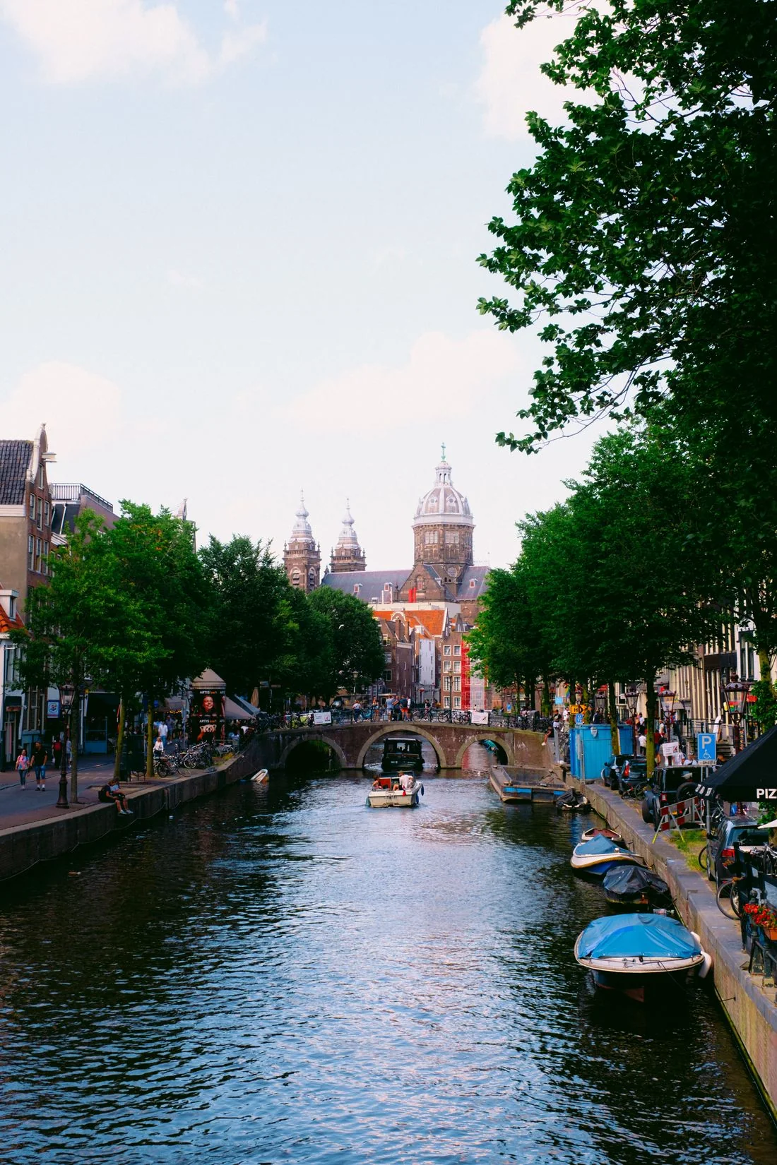 Boats and historic buildings beside an Amsterdam canal